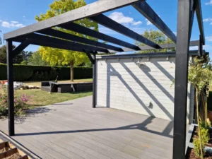 Pergola frame installation over composite decking in Suffolk garden