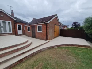Side angle showing spacious porcelain patio with curved bullnose step design