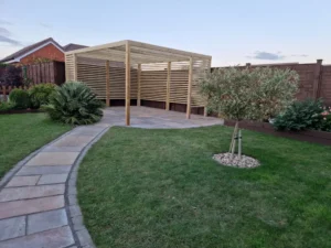 Curved sandstone patio pathway leading through landscaped Stowupland garden